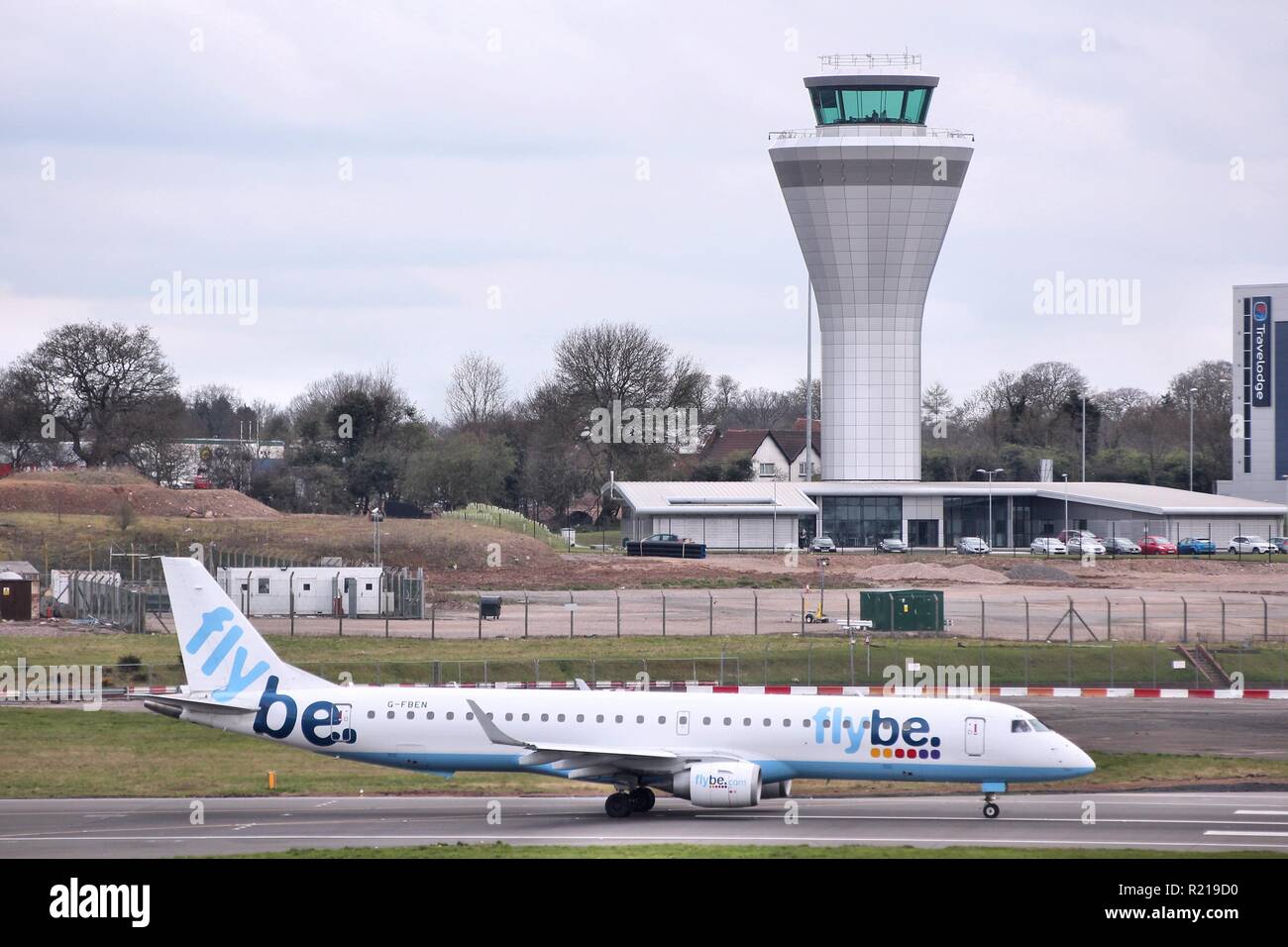BIRMINGHAM, UK - APRIL 24, 2013: Pilots taxi Flybe Embraer E-195 at Birmingham Airport, UK. Flybe carried 7.6 million passengers in 2013. Stock Photo