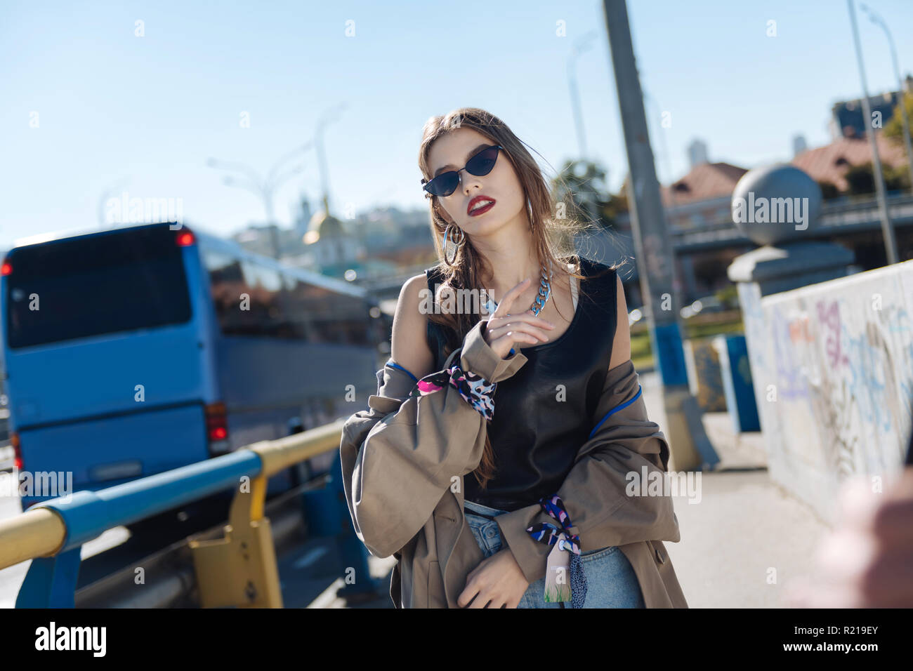 Stylish young woman walking the street wearing beige trench coat Stock ...
