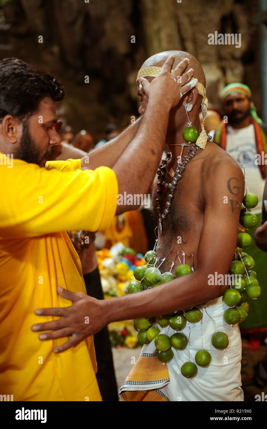 BATU CAVE, MALAYSIA - 31 JAN 2018 : Hindu priest performing the kavadi unmounting ceremony during Thaipusam celebration 2018. Stock Photo