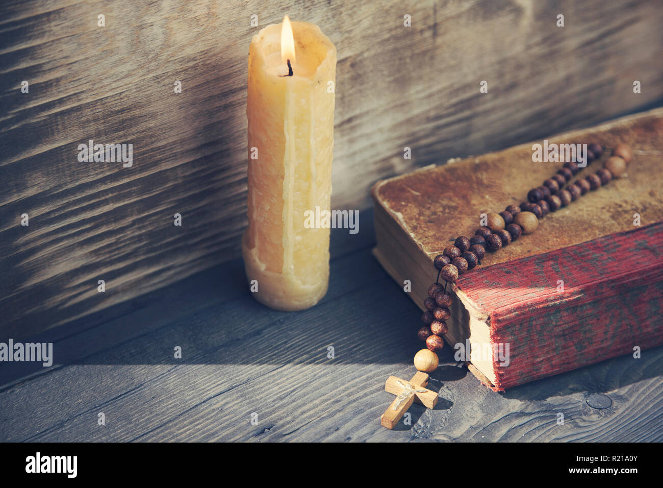 cross, book and candle on wooden background Stock Photo
