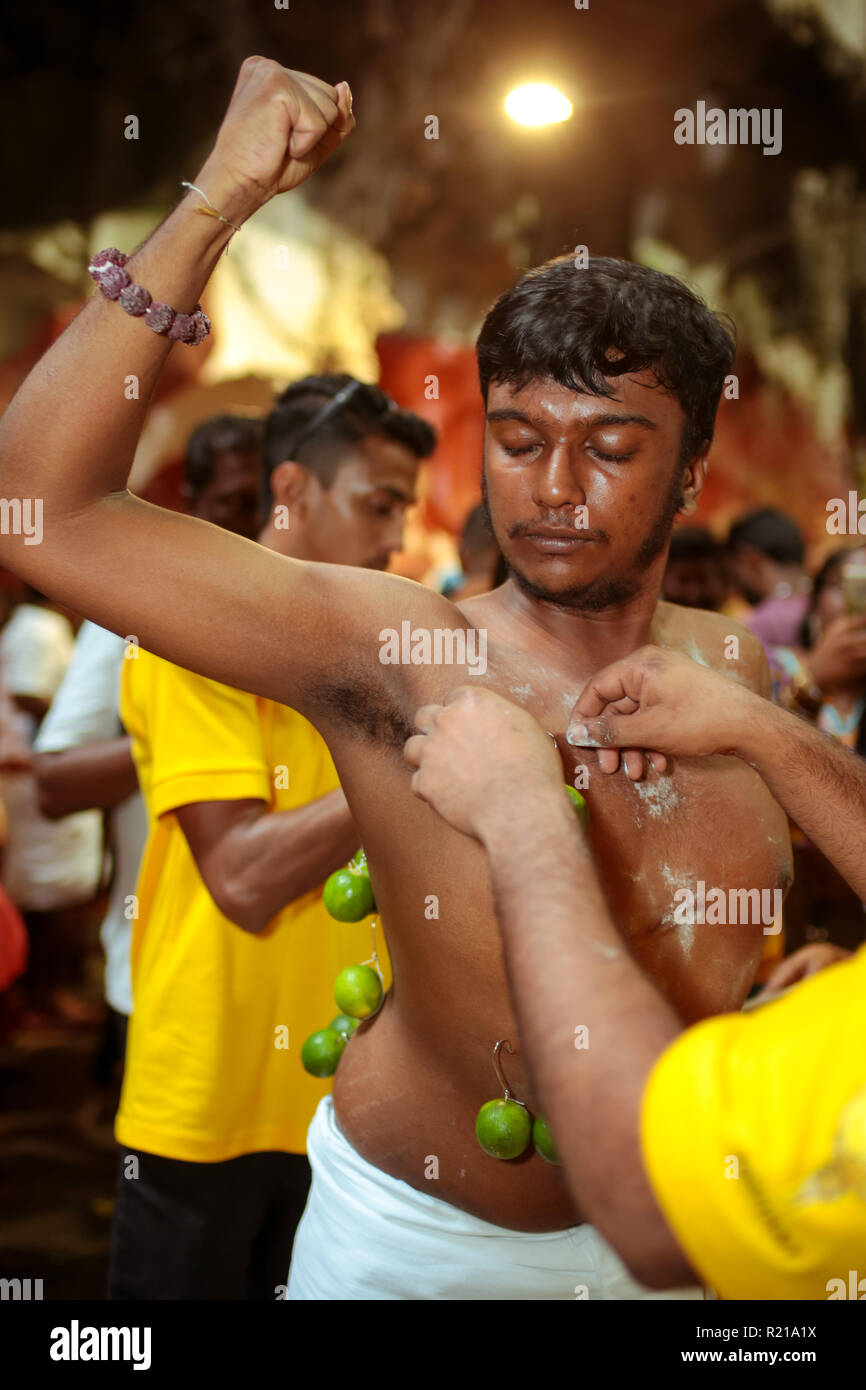 BATU CAVE, MALAYSIA - 31 JAN 2018 : The bearer stretch out his arm when hindu priest performing the kavadi unmounting ceremony during Thaipusam celebr Stock Photo