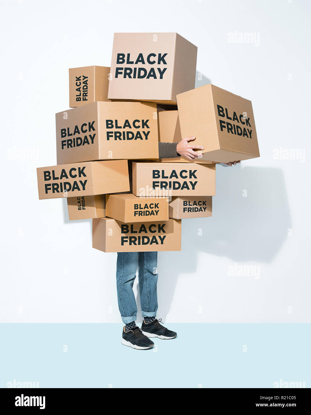 The lot of gift boxes in the hands of young man on white studio background. Cyber monday, shopping, holiday, happy Christmas, sales season start concept Stock Photo