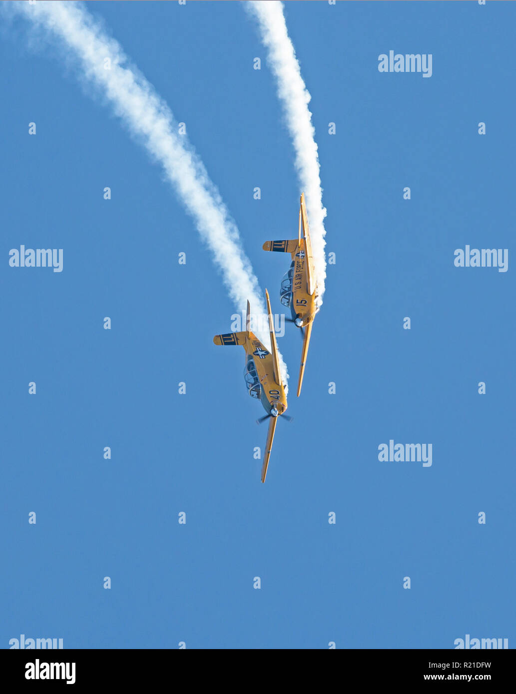 MONROE, NC (USA) - November 10, 2018: Two aerobatic aircraft perform a deep dive in a blue sky at the Warbirds Over Monroe Air Show. Stock Photo