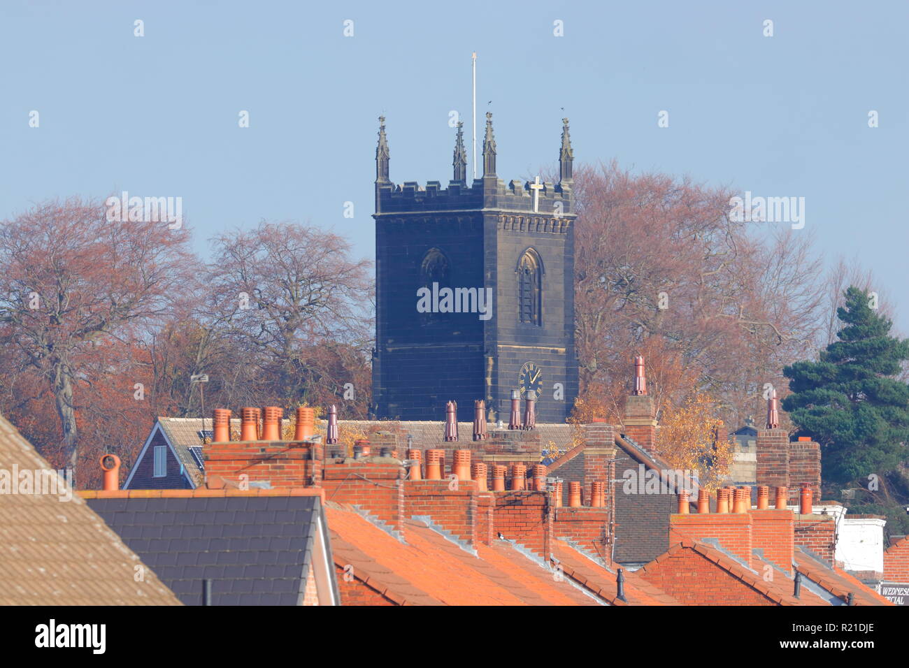 Rooftops of homes in Swillington with St Mary's Church Tower Stock