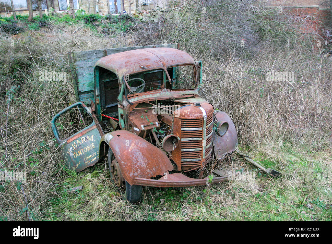Abandoned old derelict and rusty 1940's Bedford M Series or O Series truck on waste ground surrounded by weeds and grass, County Durham UK Stock Photo
