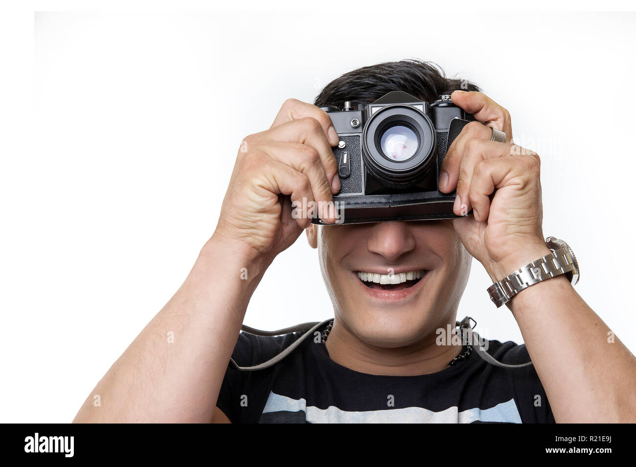 happy young man with camera on a white background Stock Photo