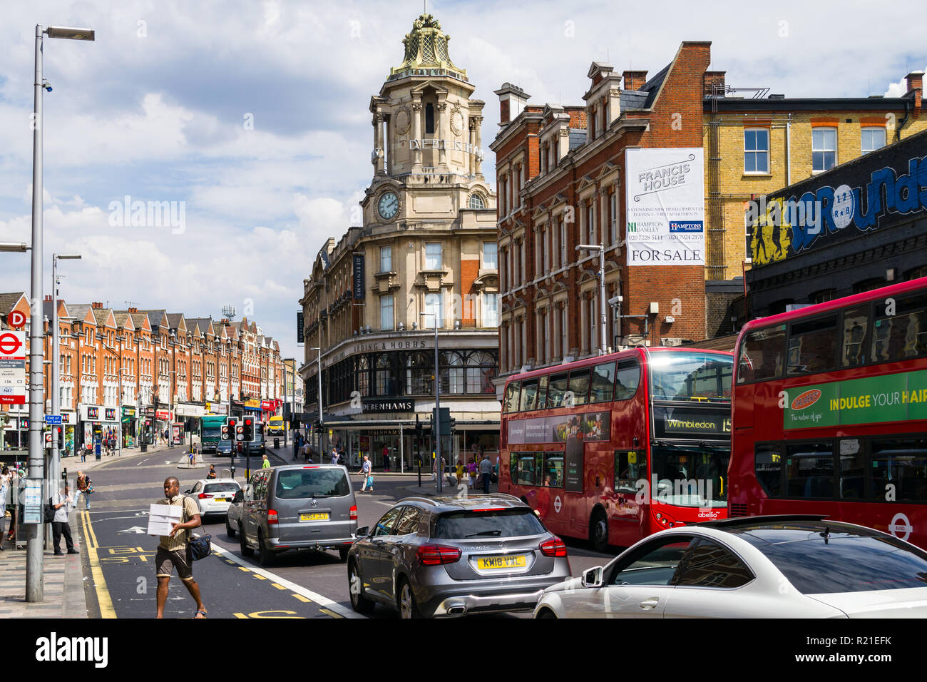 View of St. John's Hill with vehicles, buildings and people on a sunny Summer day, Clapham Junction , Wandsworth, London, UK Stock Photo