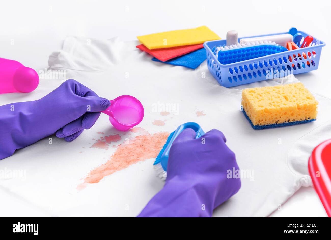 Female hands in gloves applied liquid stain remover Stock Photo Alamy