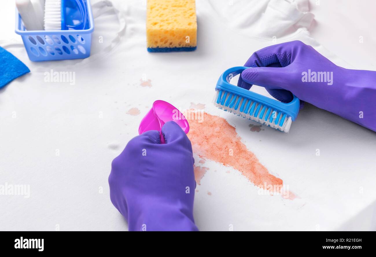 Female hands in gloves applied liquid stain remover Stock Photo Alamy