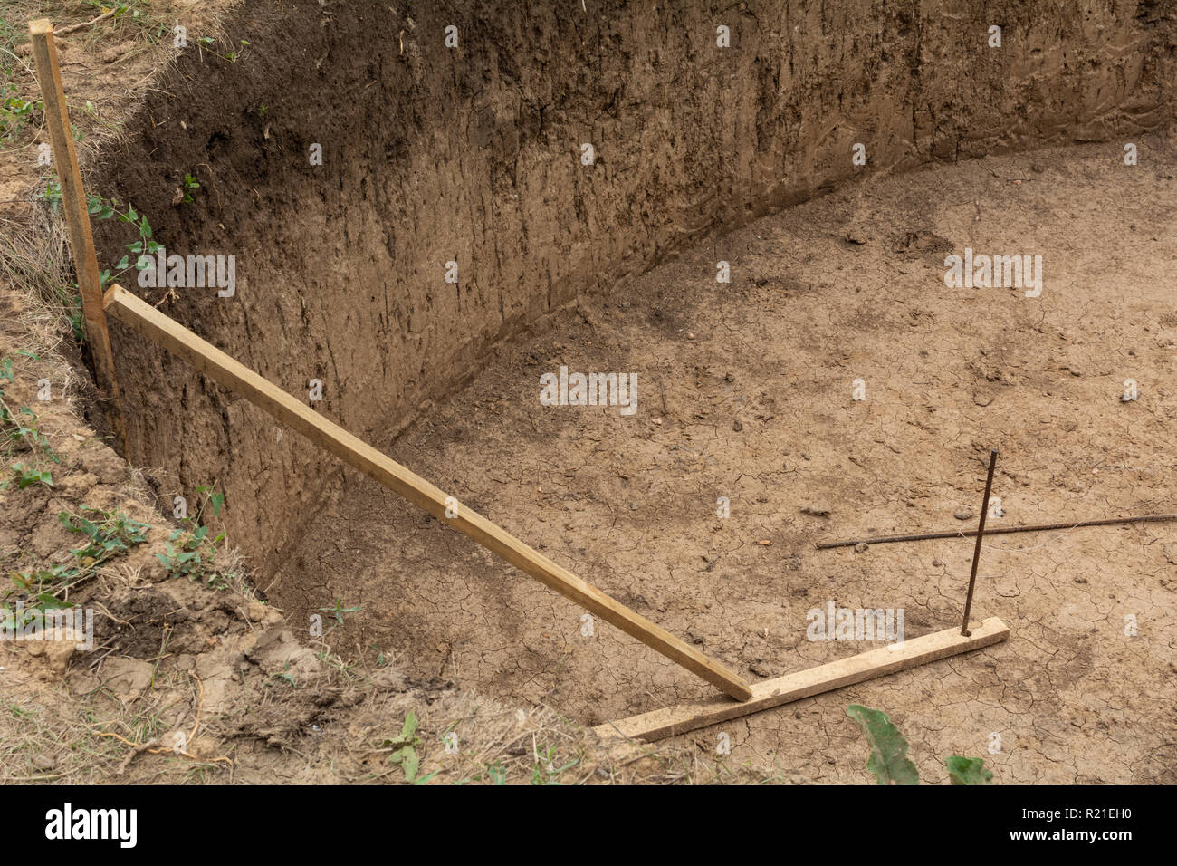 Fish pond under construction with dried soil in Ukraine village Stock