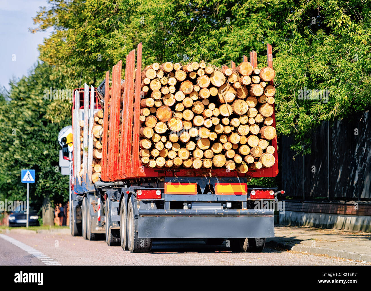 Wood carrier vessel in the road in Poland. Lorry transport delivering