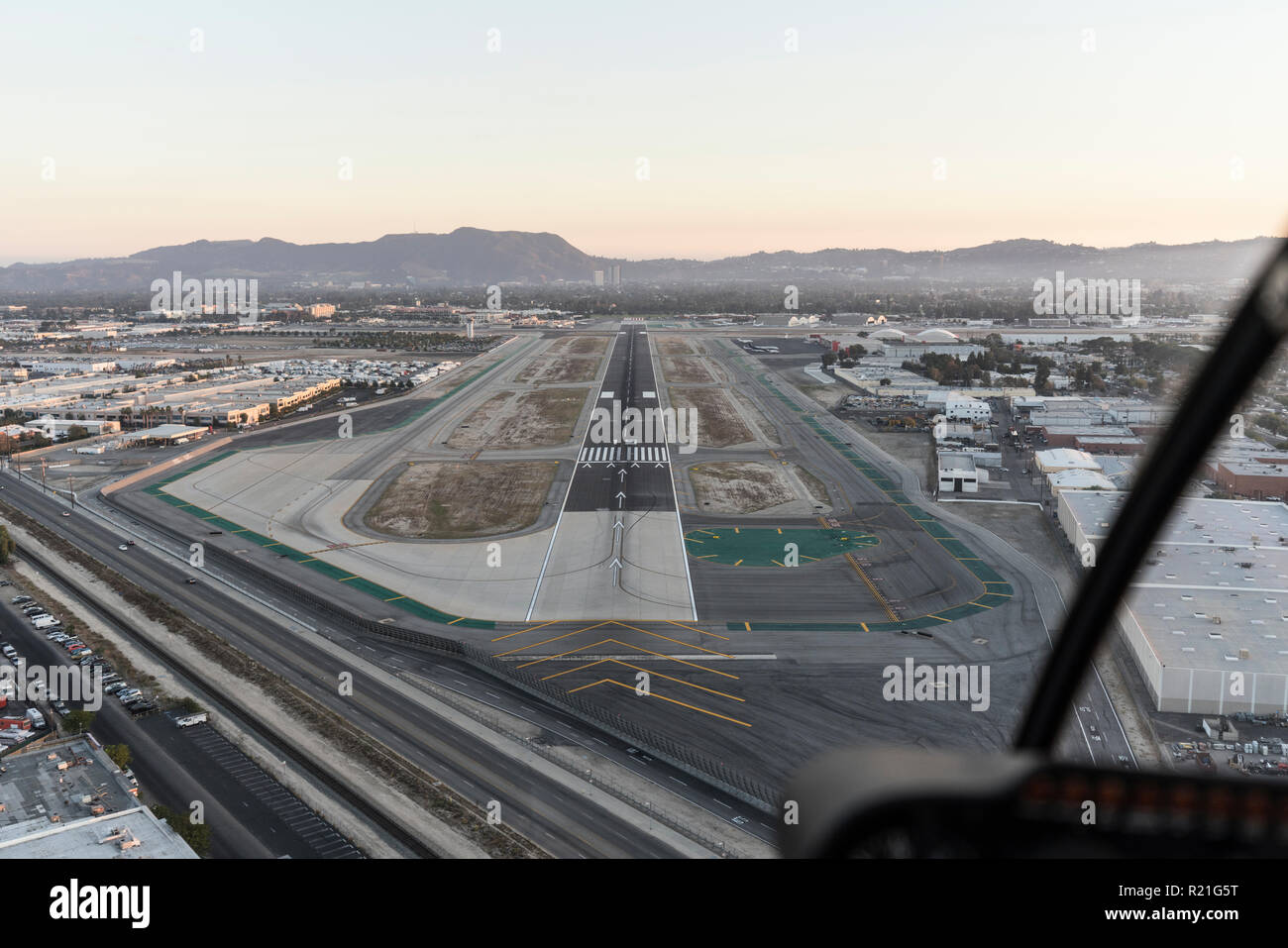 Late afternoon aerial view of airport runway approach in the San Fernando Valley area of Southern California. Stock Photo