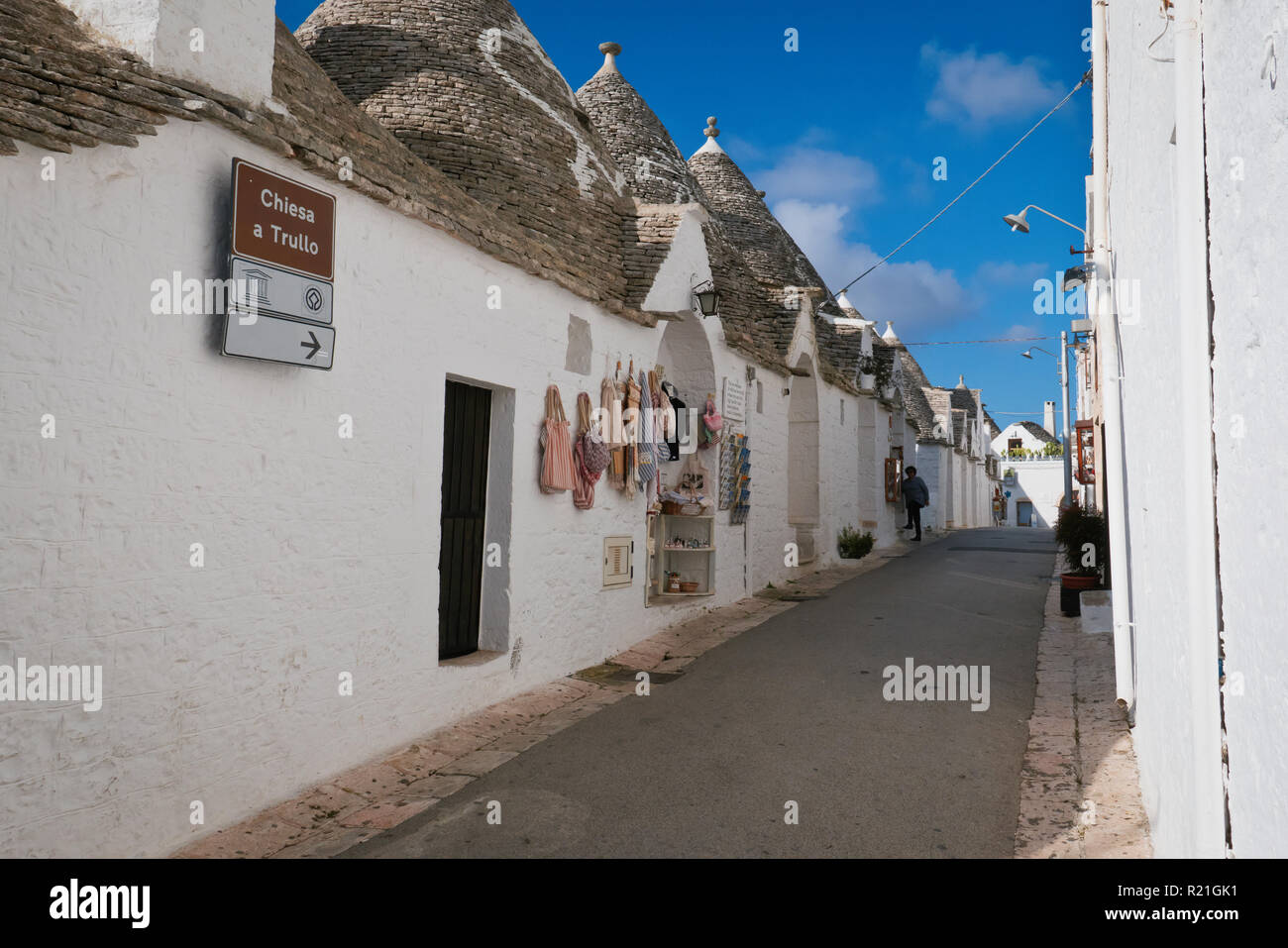 Alley of Trulli house in the morning with shops. Stock Photo