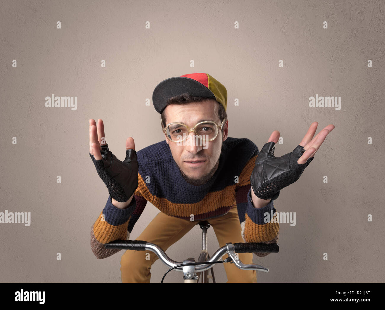 Nerd young foolish biker on a bike with oldschool outfit Stock Photo ...