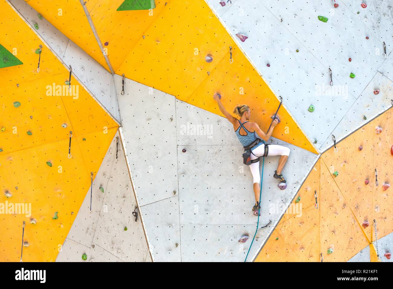 bouldering, girl climbing up the wall Stock Photo Alamy