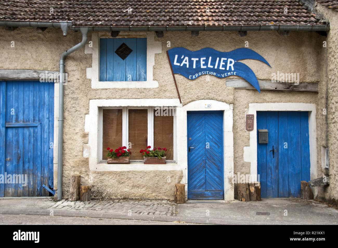 Colorful blue doors on a craftsman's workshop near the birthplace of Joan of Arc in Domremy-la- Pucelle, France. Stock Photo