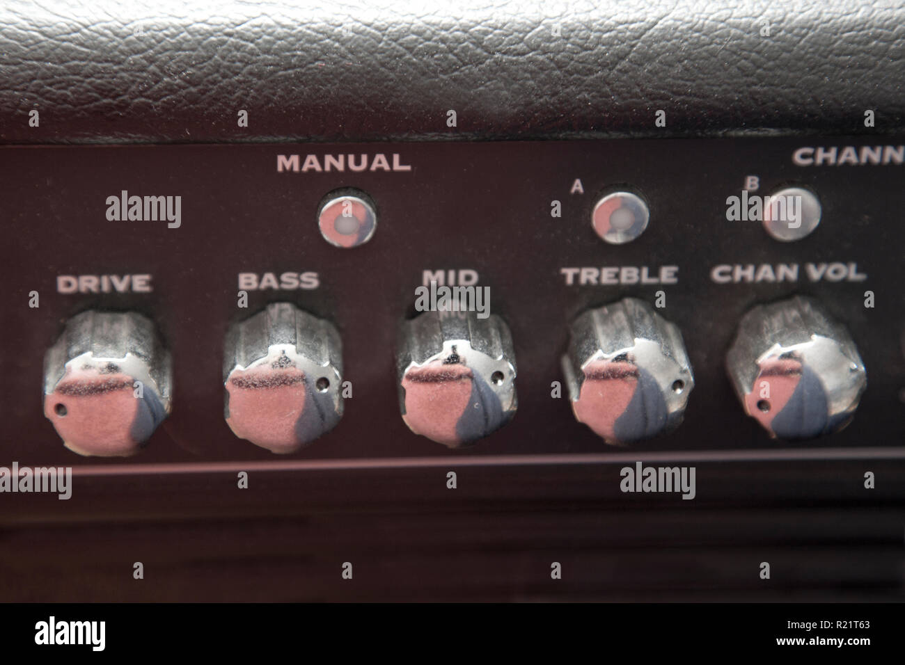 Dials that set the range and channel for a guitar amplifier Stock Photo