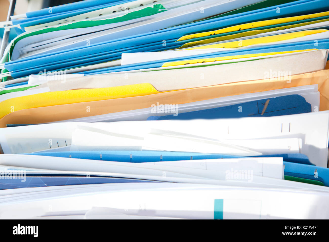 A messy drawer or cabinet with filed papers and documents sorted in folders Stock Photo