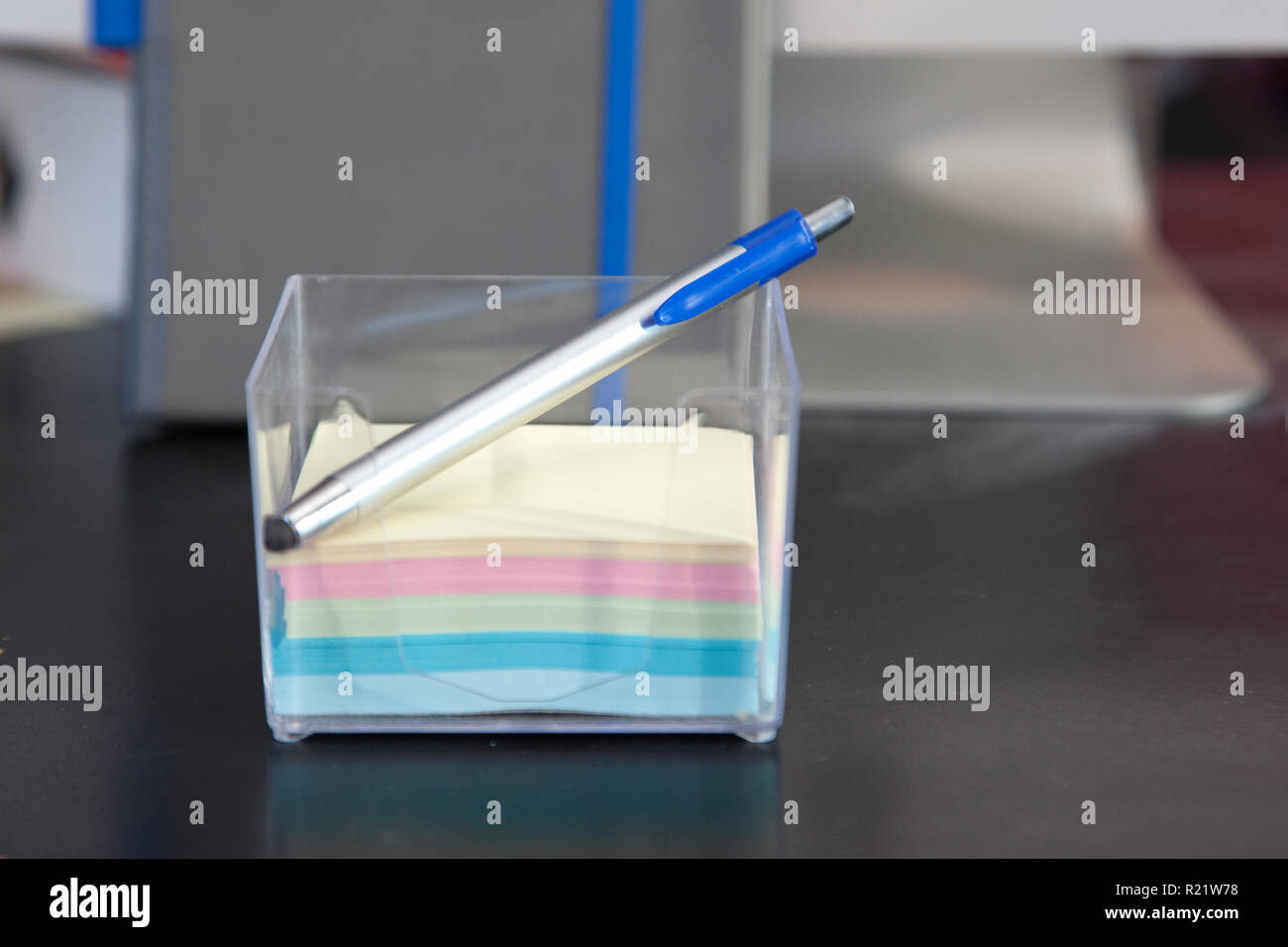 Stack of sticky notes and a pen on a desk Stock Photo