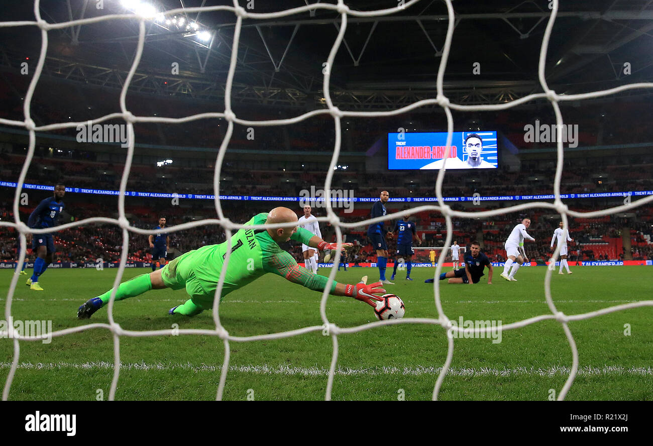 USA goalkeeper Brad Guzan saves from England's Wayne Rooney during the International Friendly at Wembley Stadium, London. Stock Photo