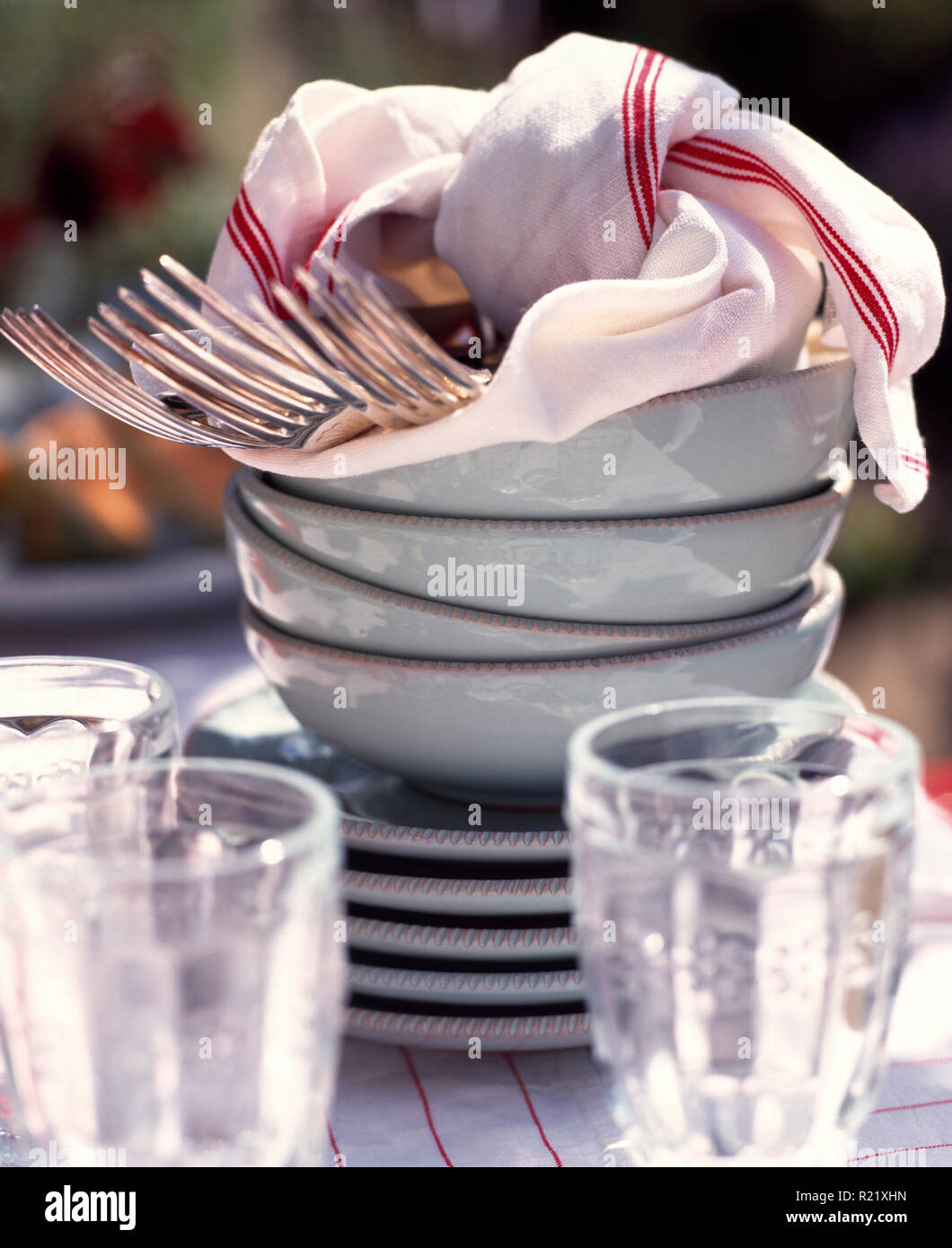 Close-up of forks on stack of white bowls Stock Photo