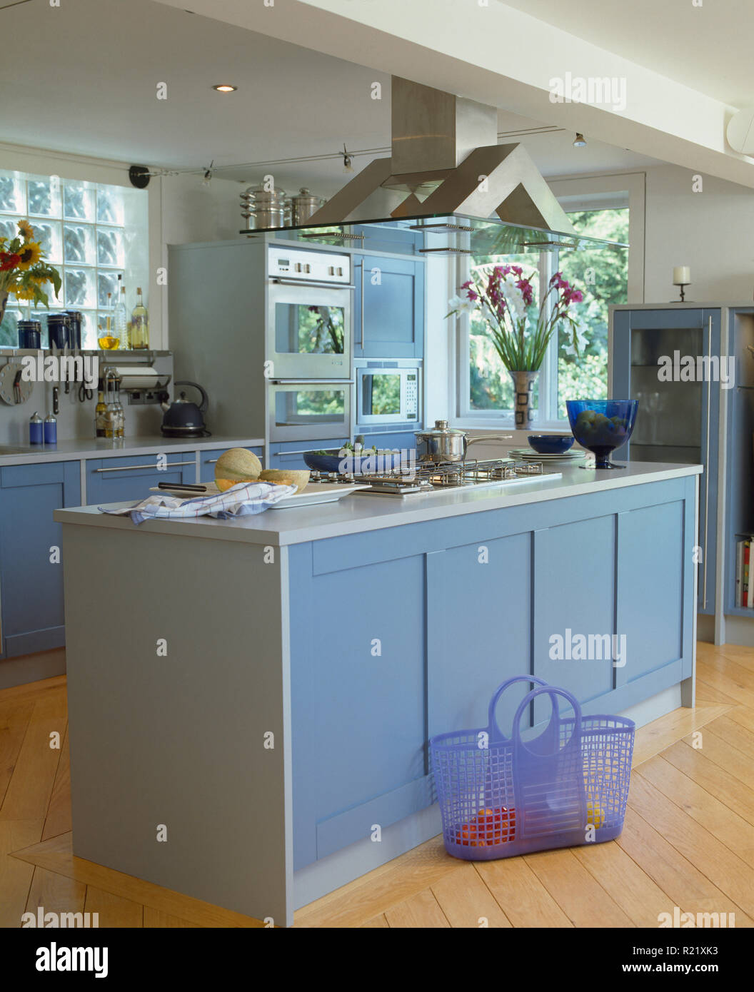 Pale blue doors on island unit in modern kitchen Stock Photo
