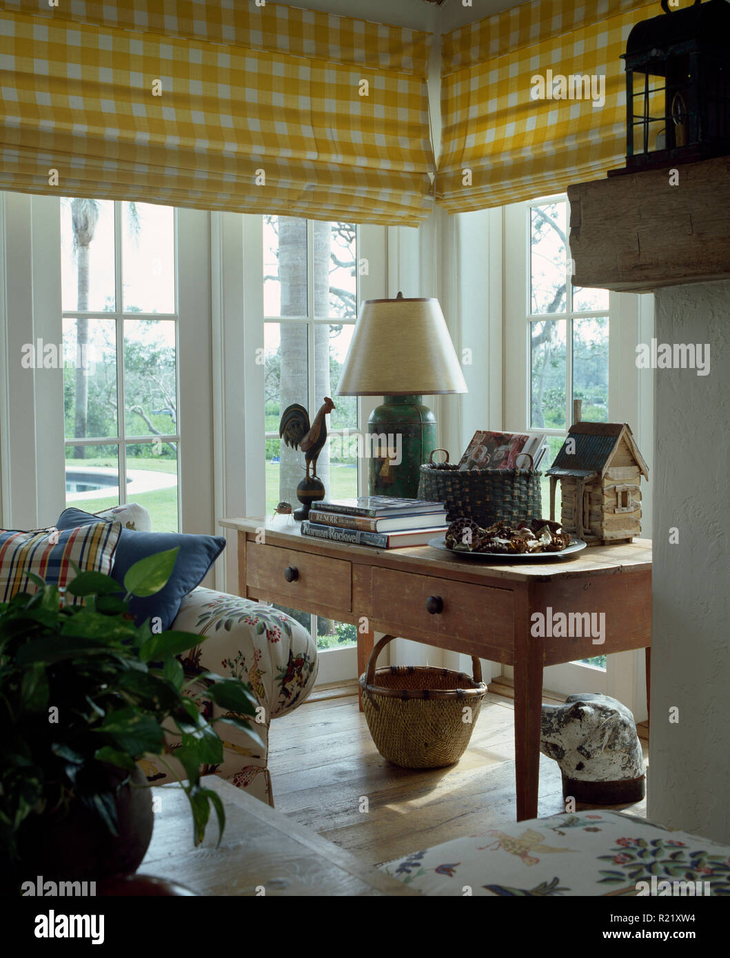 Yellow+white checked blinds on sitting room windows Stock Photo