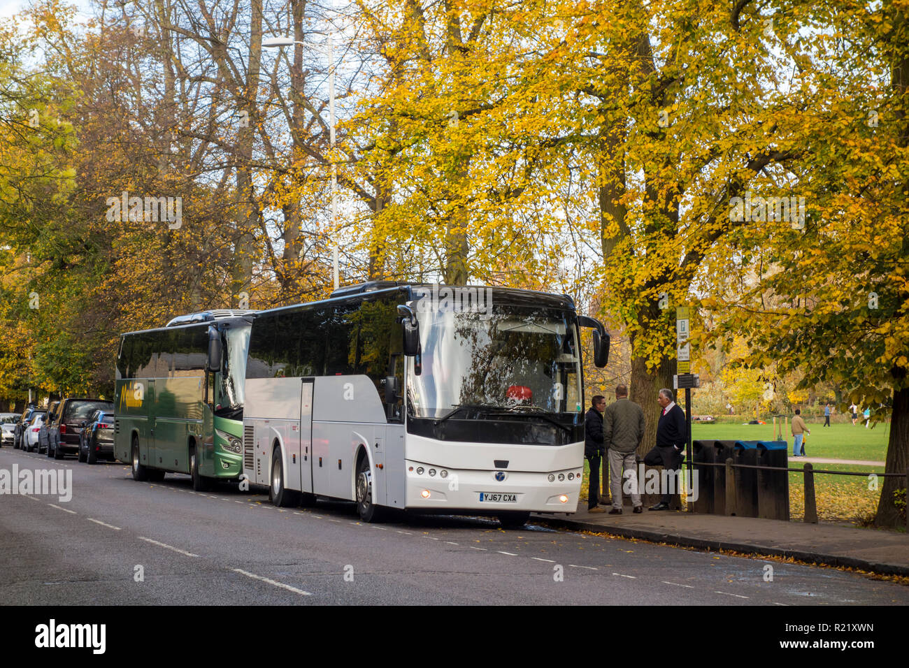 Tourist coaches and buses parked on The Backs in Cambridge, UK during Autumn Stock Photo