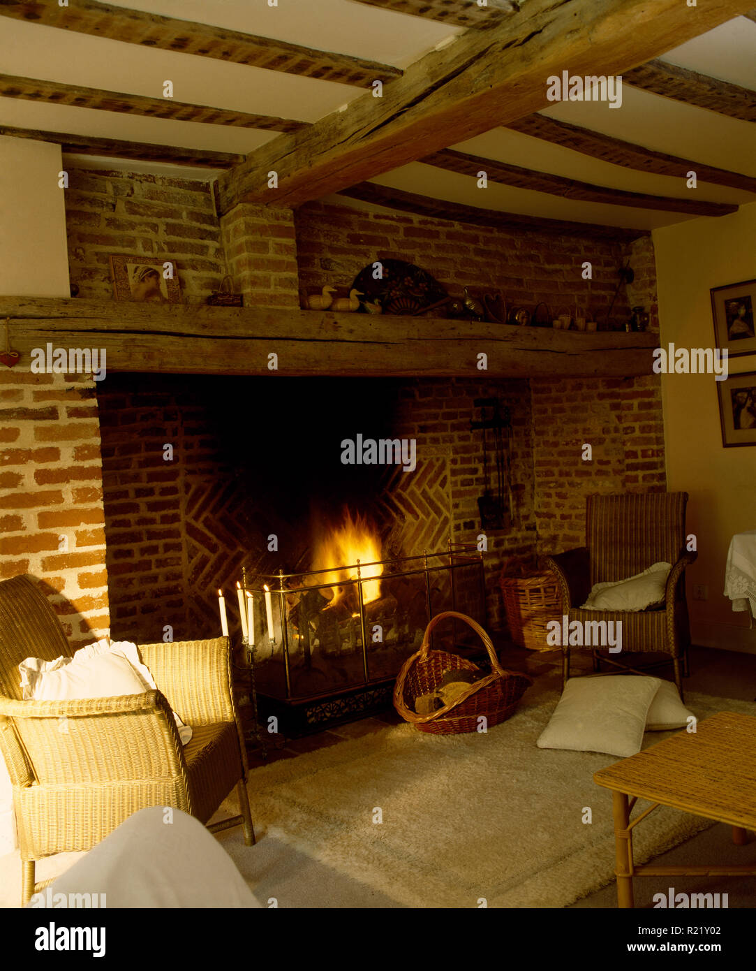 Inglenook fireplace with lighted fire in country sitting room Stock Photo
