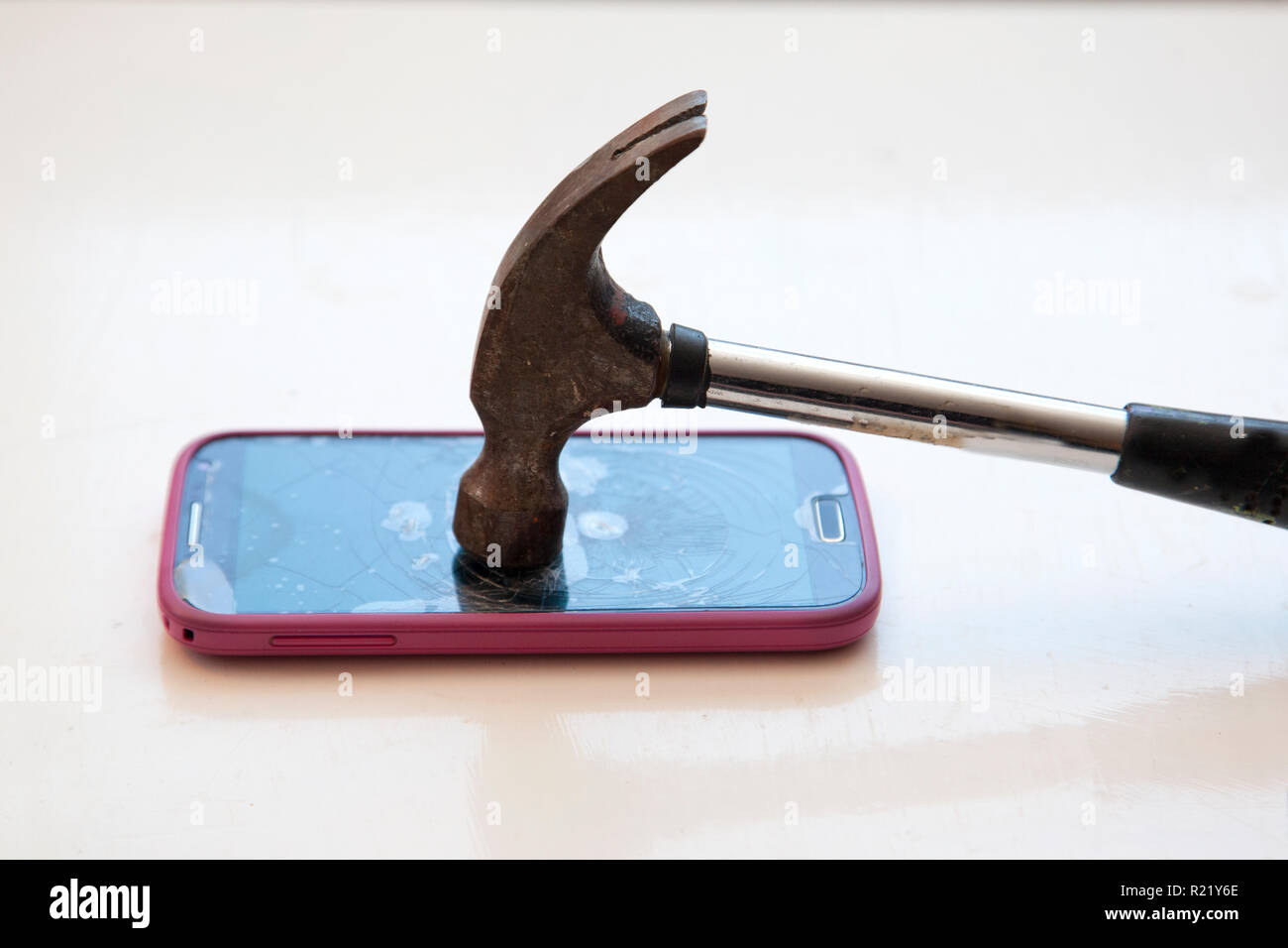 Taking a hammer and smashing a cell phone Stock Photo - Alamy
