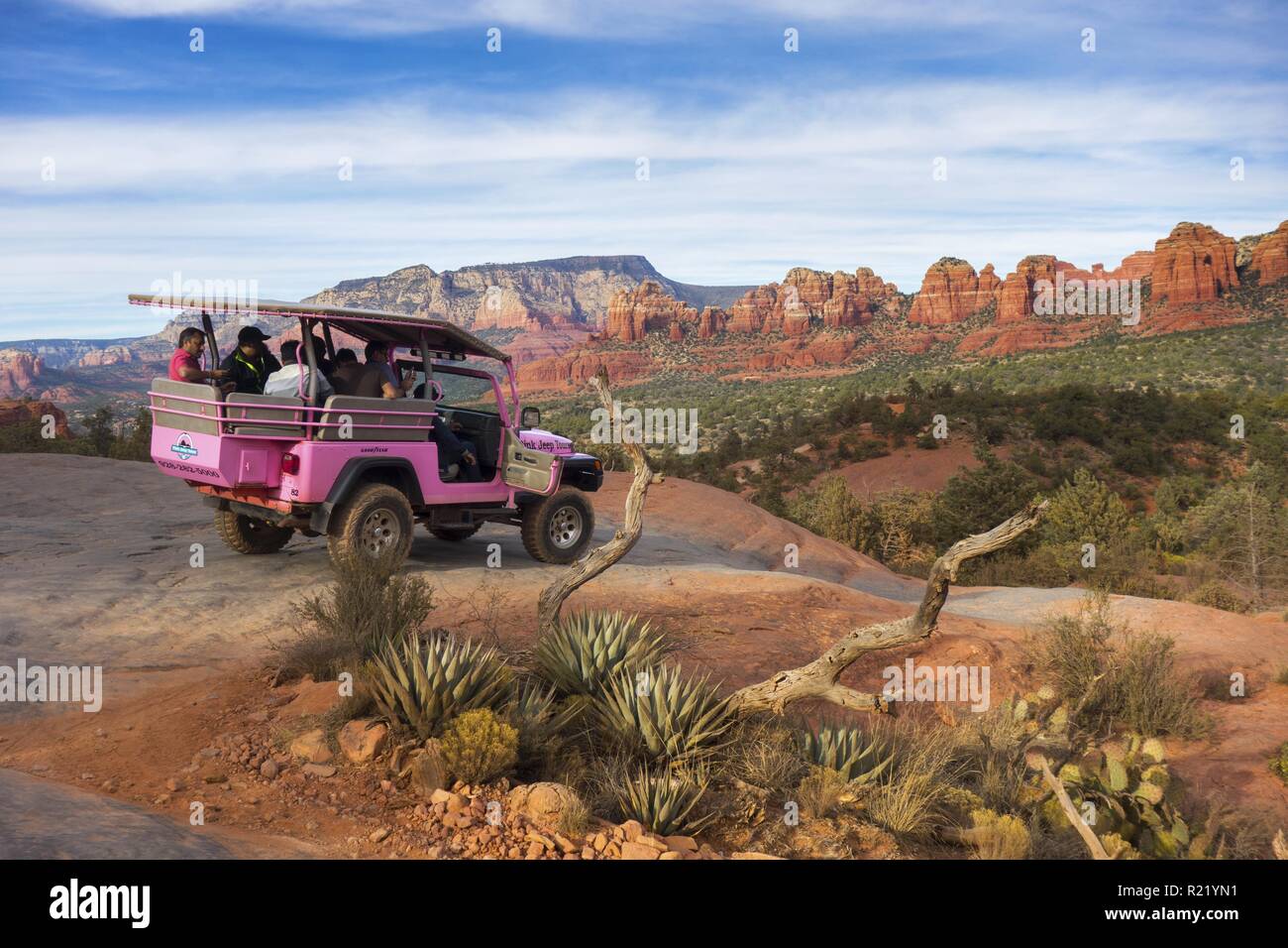 Pink Jeep Off Road Terrain High Clearance Sports Utility Vehicle with Tourists. Broken Arrow Slick Rock Tour and canyon landscape view Sedona, Arizona Stock Photo