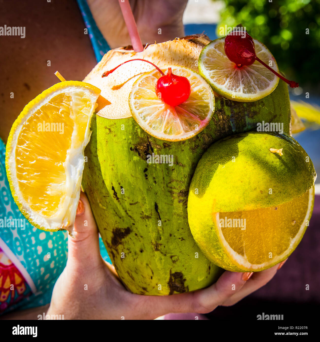 MONKEY COCONUT FRUITY DRINK ON WHITE SAND BEACH IN CANCUN MEXICO Stock