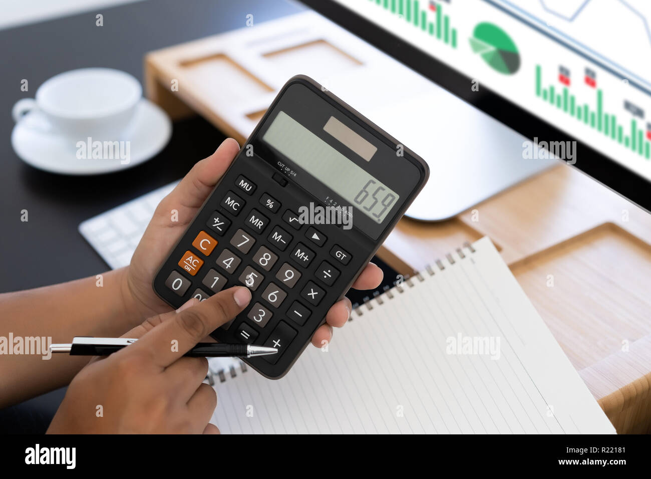 man use calculator make note with calculate about cost in office Close up  Stock Photo - Alamy