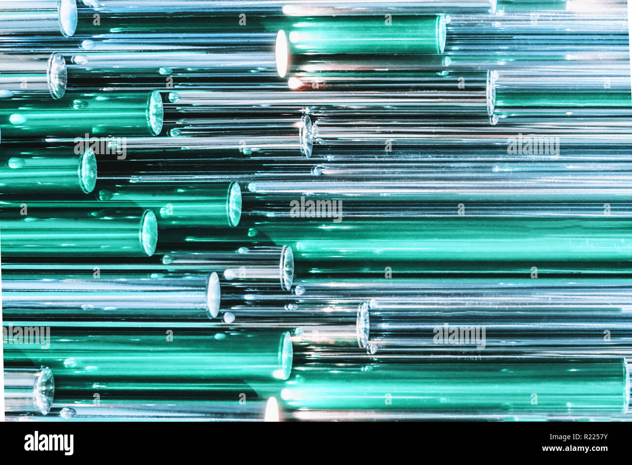 Colorful teal holographic metallic tube as texture. Iridescent wallpaper. Metal surface, trendy design. Abstract background. Stock Photo