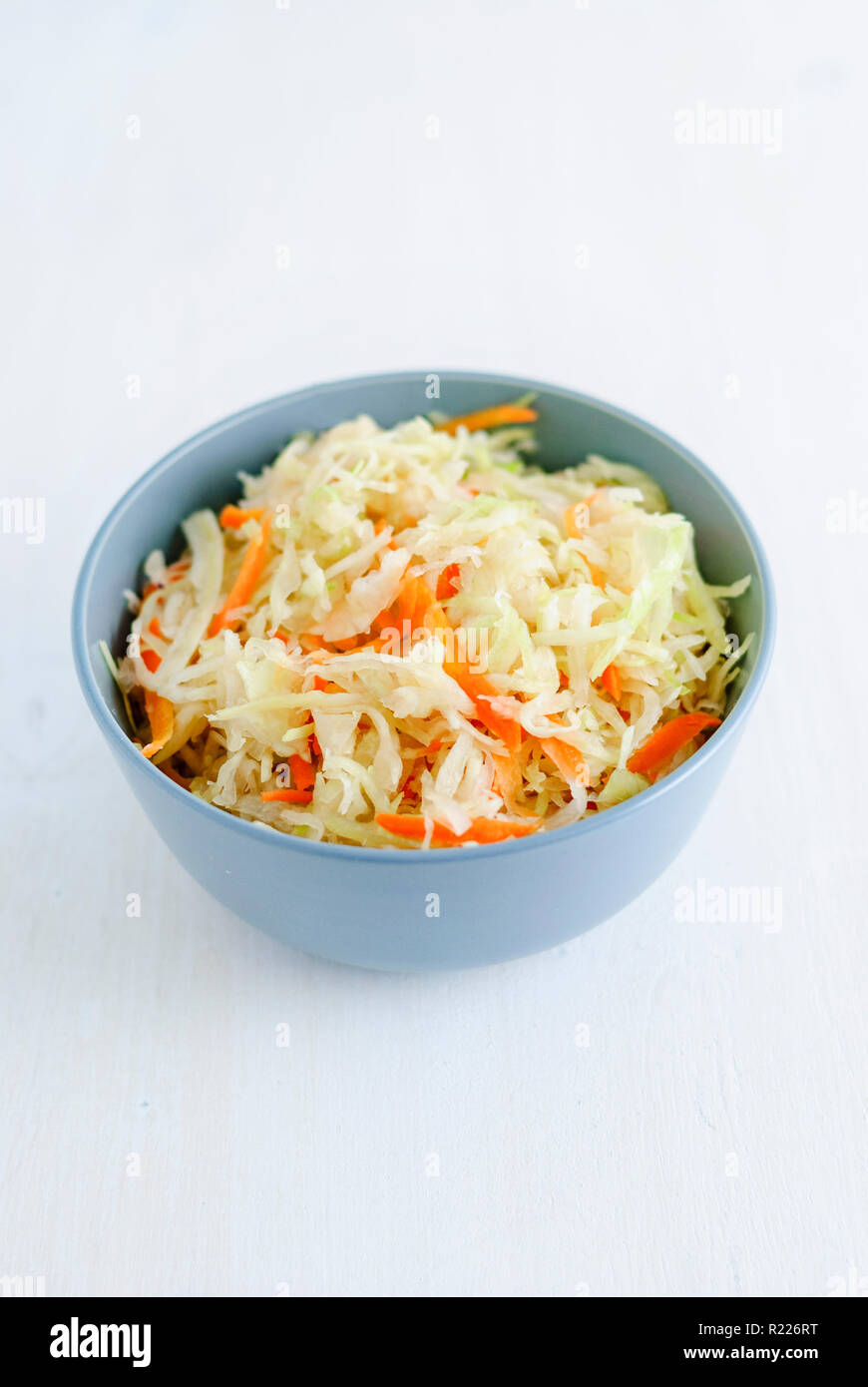 Bowl with fermented cabbage on napkin Stock Photo