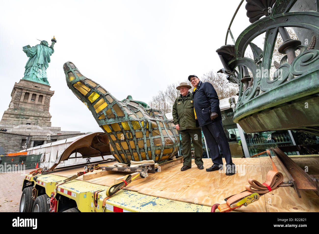 New York, USA, 15 November 2018. Stephen Briganti, President and CEO of The Statue of Liberty-Ellis Island Foundation (R) and  John Piltzecker, Superintendent of the Statue of Liberty National Monument and Ellis Island, pose next to the original torch of the Statue of Liberty and a replica of  its face before they get ransported to their new Statue of Libery Museum that is expected to open in May 2019.  Photo by Enrique Shore Credit: Enrique Shore/Alamy Live News Stock Photo