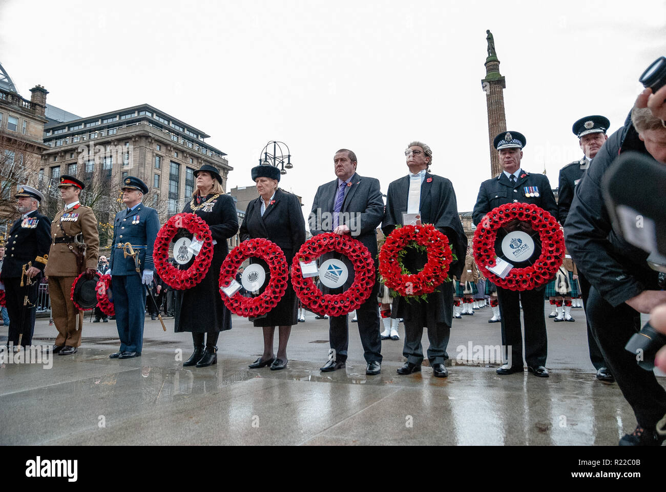 High ranking officials from various services and forces are seen standing before the Cenotaph with wreaths to pay their respects to those who have fallen.  Members of the UK armed forces, Police Scotland, Public and other services came out in support and to pay respects to those that have fallen in recent conflicts and to those that fell during the Great War. 2018 marked the 100th Year anniversary of WW1. Stock Photo