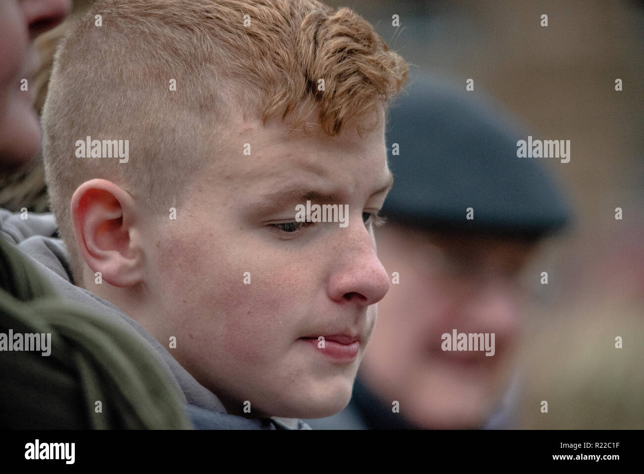 A portrait of a member of the public is seen watching the parade as it unfolds in George Square.  Members of the UK armed forces, Police Scotland, Public and other services came out in support and to pay respects to those that have fallen in recent conflicts and to those that fell during the Great War. 2018 marked the 100th Year anniversary of WW1. Stock Photo