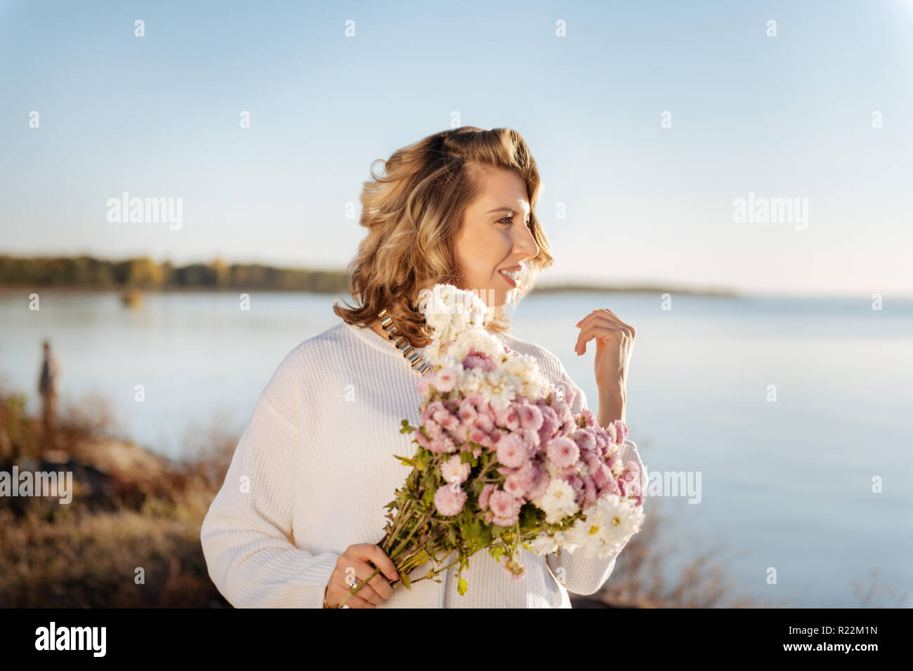 Woman walking with a bunch of flowers outdoor Stock Photo - Alamy