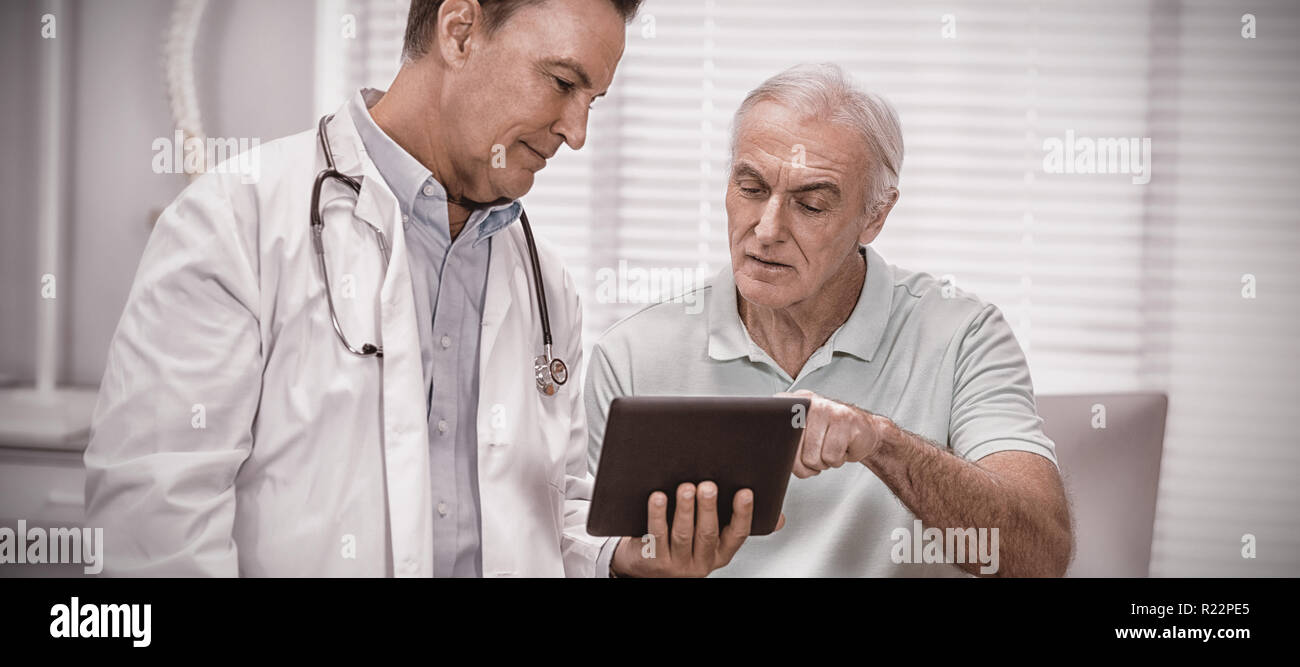 Doctor and senior patient using digital tablet Stock Photo