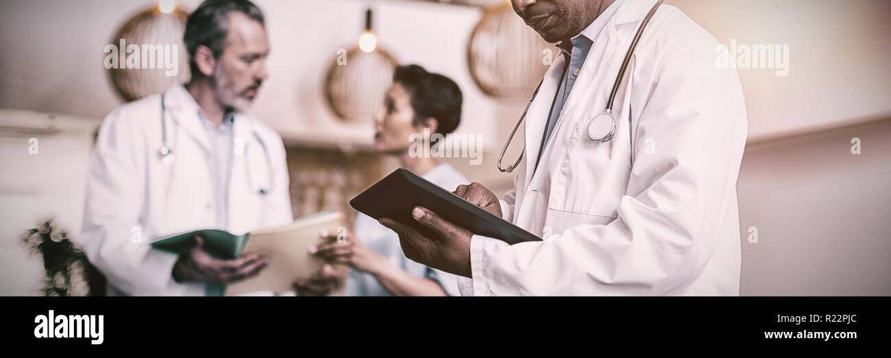 Doctor using digital tablet Stock Photo