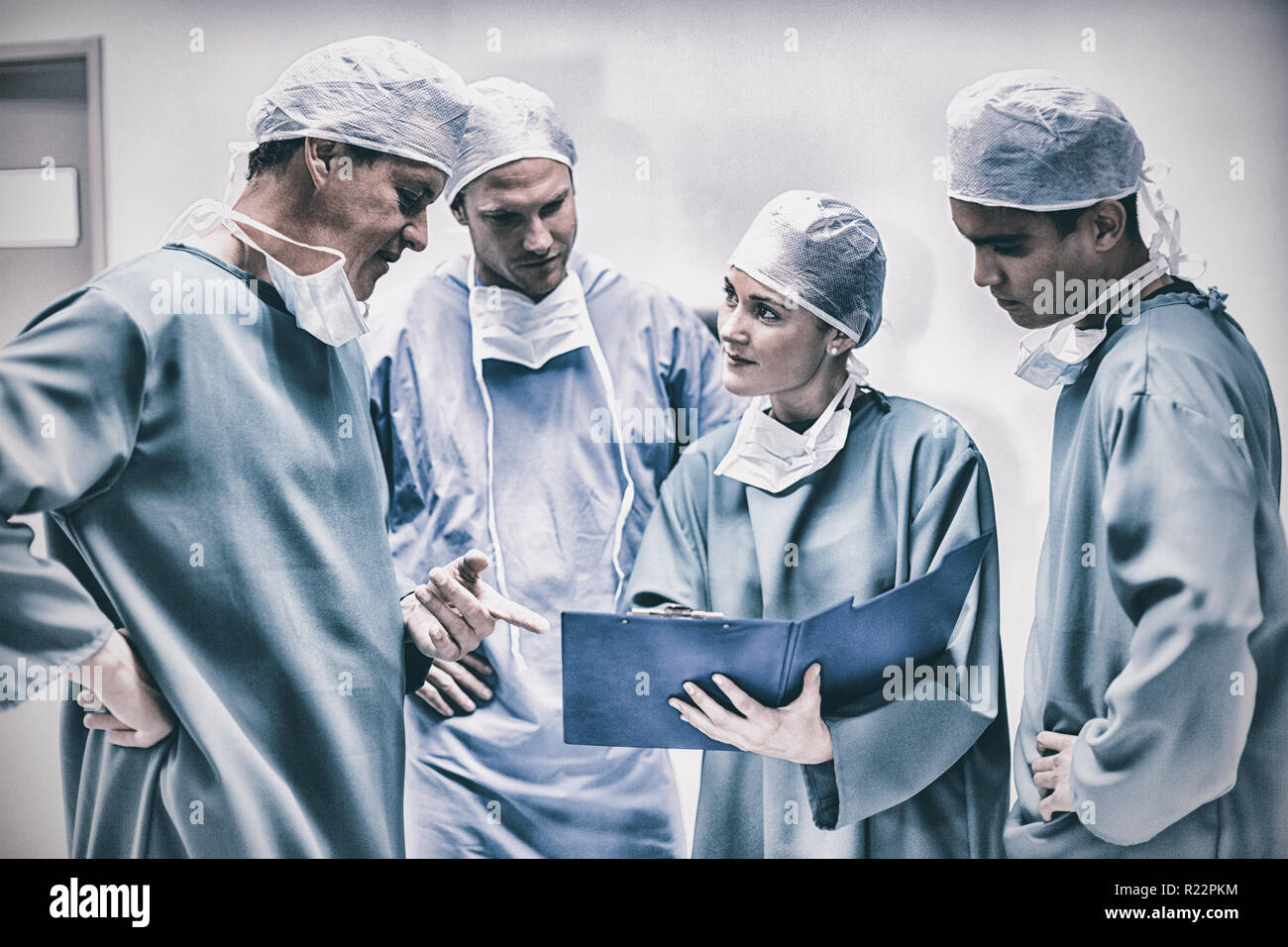 Surgeons having discussion on file in corridor Stock Photo
