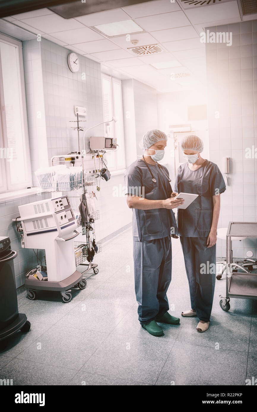 Surgeons discussing over digital tablet Stock Photo
