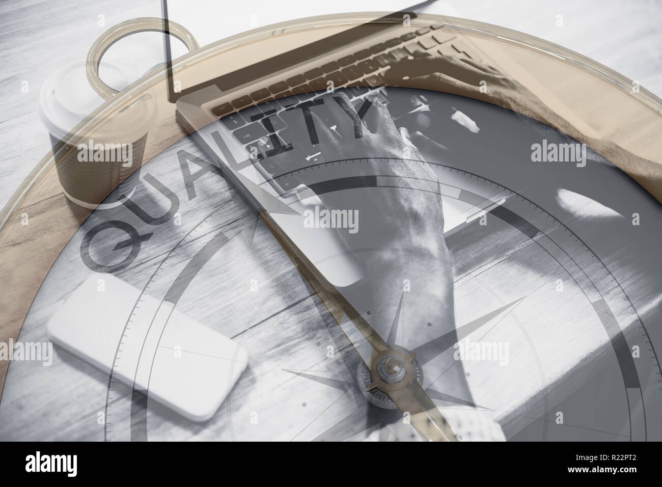 Composite image of compass pointing to quality Stock Photo