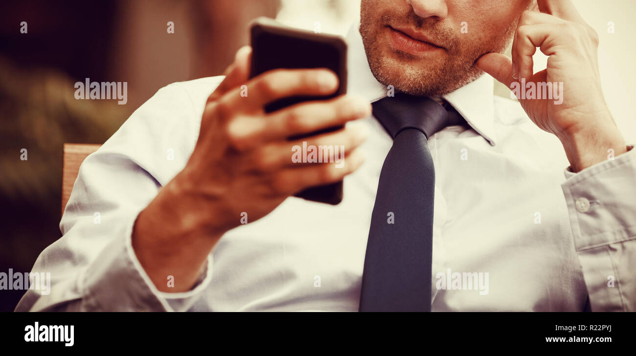 Tensed businessman using mobile phone Stock Photo
