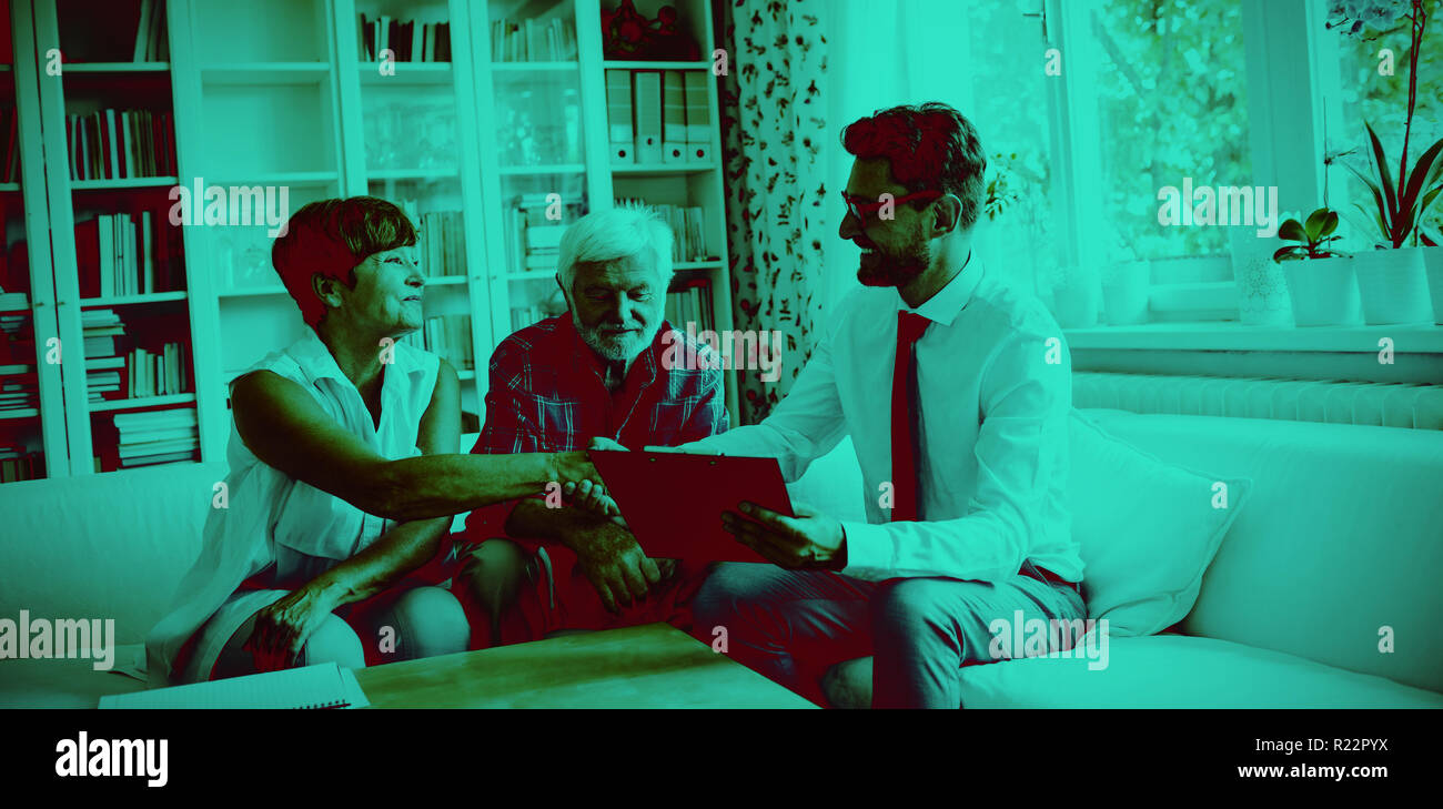 Financial advisor shaking hands with senior woman Stock Photo