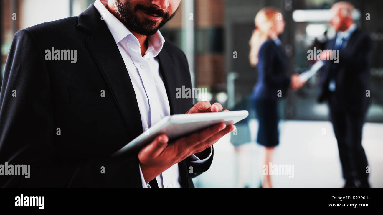 Smart businessman using digital tablet Stock Photo