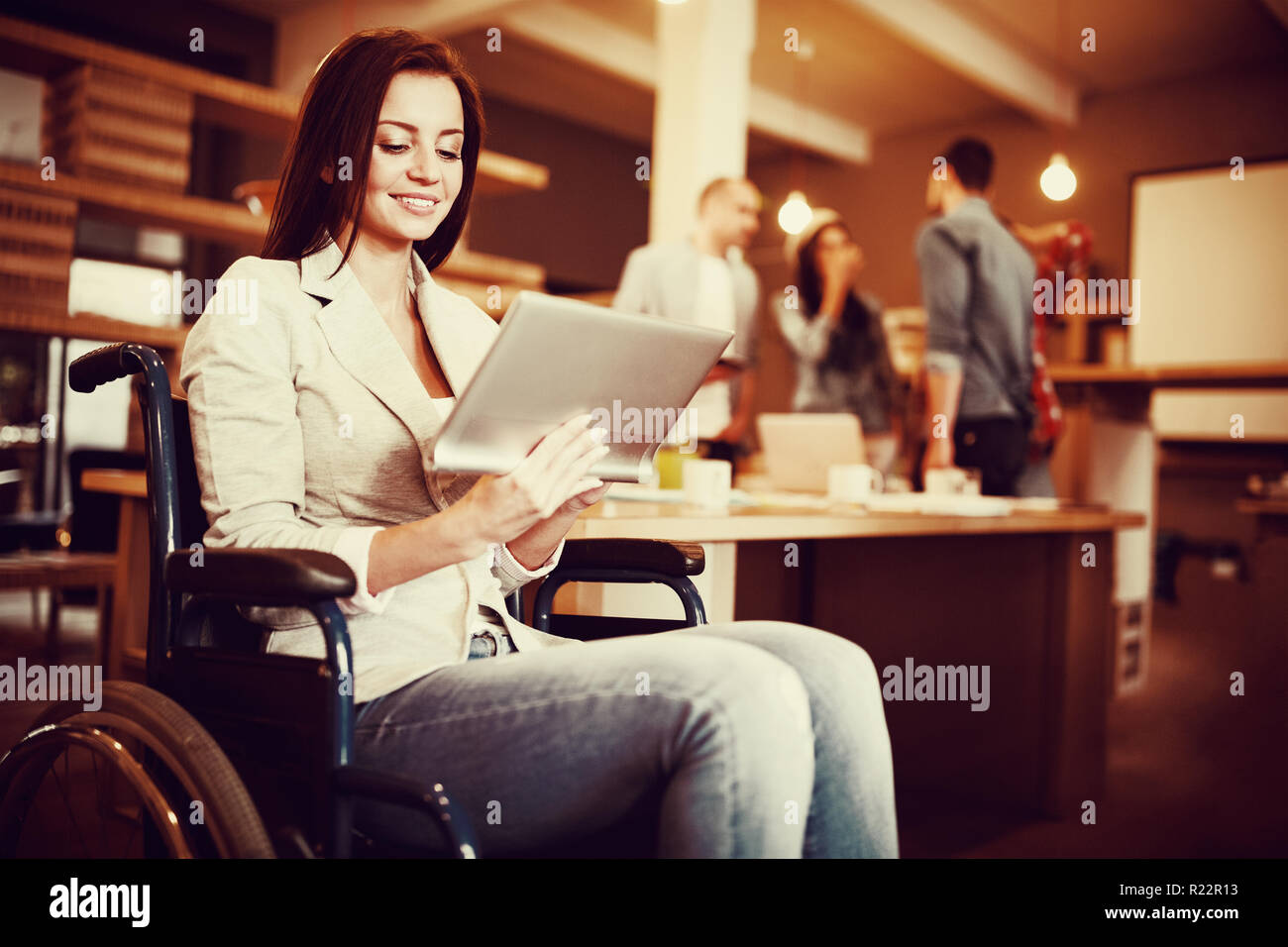 Disabled young businesswoman using digital tablet Stock Photo