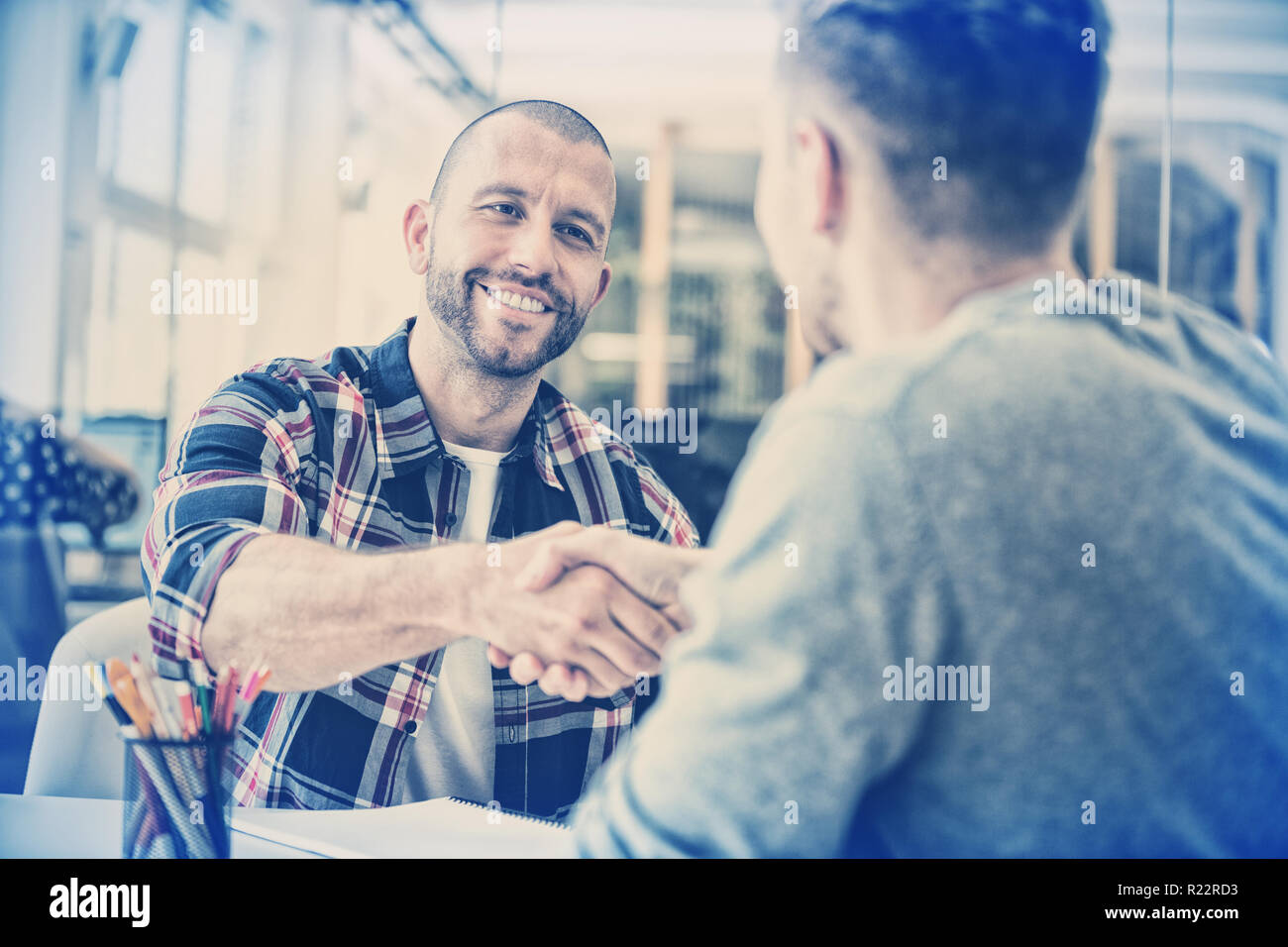 Confident business people shaking hands Stock Photo