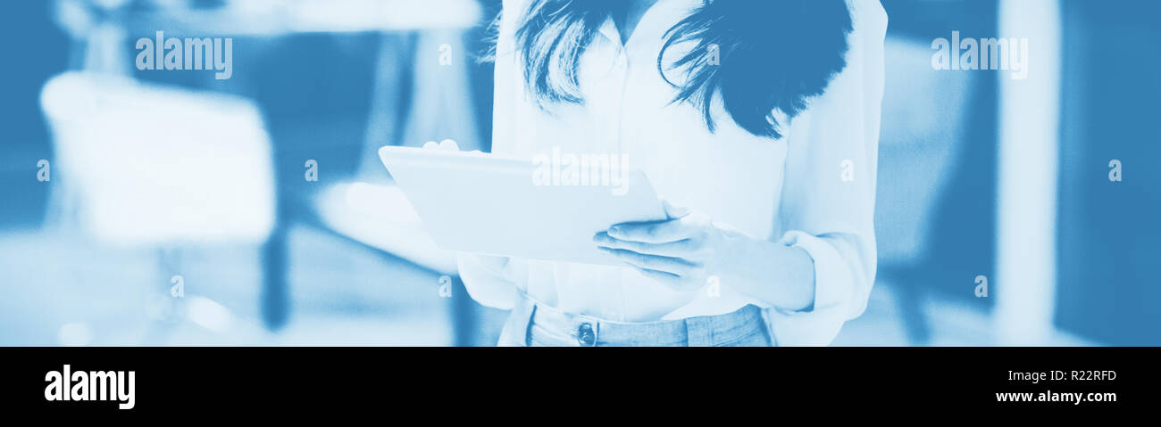 Smiling businesswoman using digital tablet Stock Photo
